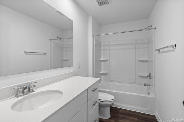 bathroom featuring shower / bath combination, visible vents, toilet, vanity, and wood finished floors