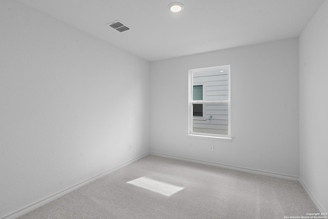 carpeted spare room with baseboards and visible vents