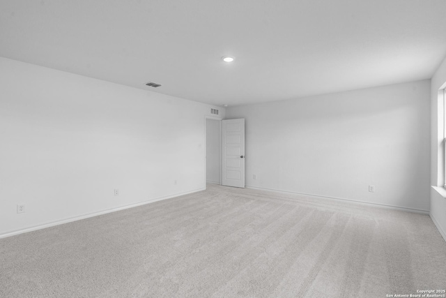 unfurnished room featuring light carpet, recessed lighting, visible vents, and baseboards