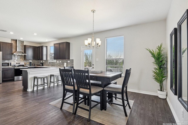 dining area with an inviting chandelier, baseboards, dark wood-style flooring, and a wealth of natural light