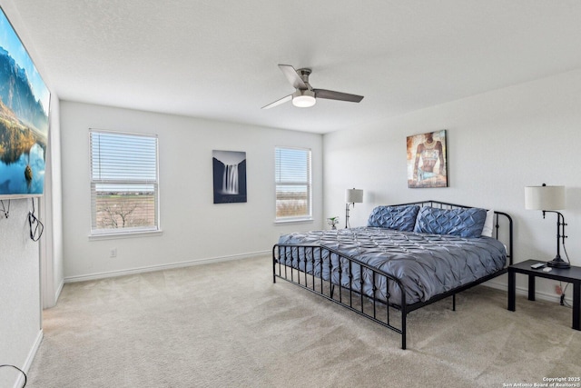 bedroom featuring carpet, multiple windows, and baseboards