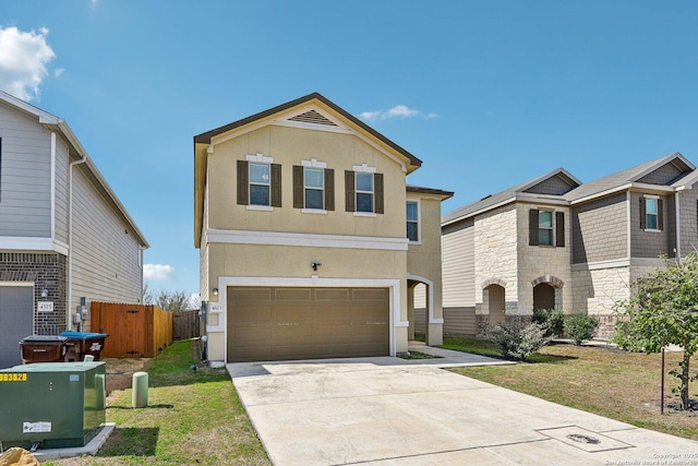 view of front of home featuring driveway, a garage, stucco siding, fence, and a front yard