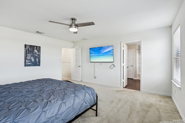 bedroom featuring carpet floors, visible vents, ensuite bathroom, a ceiling fan, and baseboards