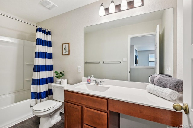 full bathroom with visible vents, toilet, shower / tub combo with curtain, wood finished floors, and vanity