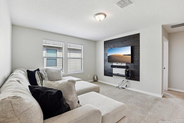 living room featuring a textured ceiling, carpet flooring, visible vents, and baseboards