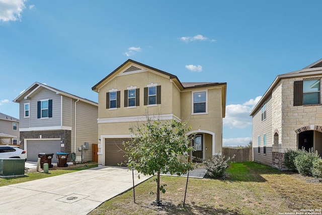 view of front facade featuring a garage, concrete driveway, fence, and stucco siding