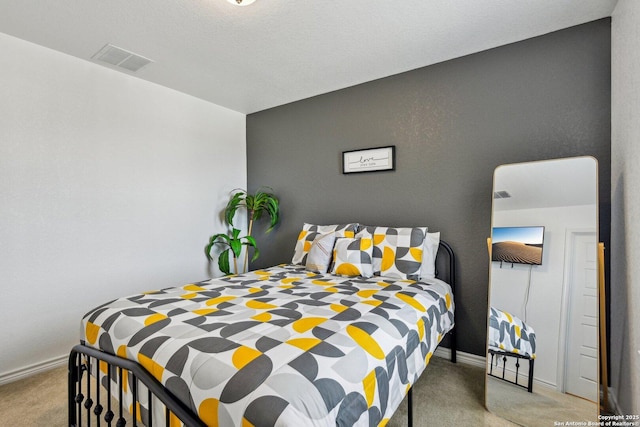 bedroom with carpet floors, baseboards, and visible vents