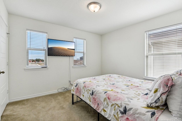 carpeted bedroom with baseboards