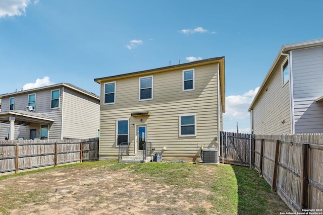 back of property featuring entry steps, a fenced backyard, a lawn, and central air condition unit