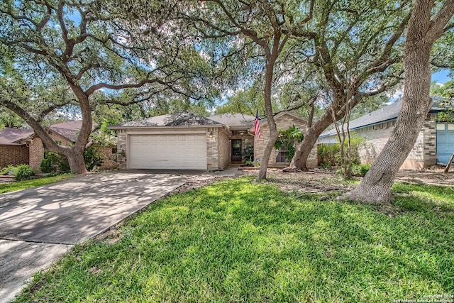 view of front of property with a front yard, brick siding, driveway, and an attached garage