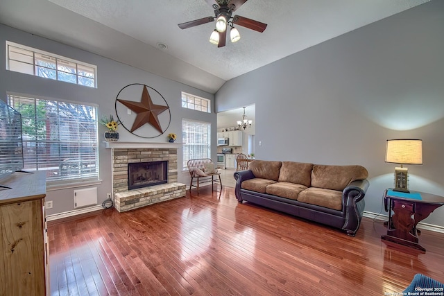 living area with hardwood / wood-style flooring, plenty of natural light, a fireplace, and baseboards