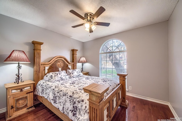 bedroom featuring dark wood-style floors, a textured ceiling, and baseboards