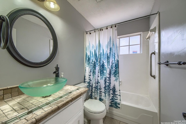 full bath with a textured ceiling, vanity, toilet, and shower / tub combo with curtain