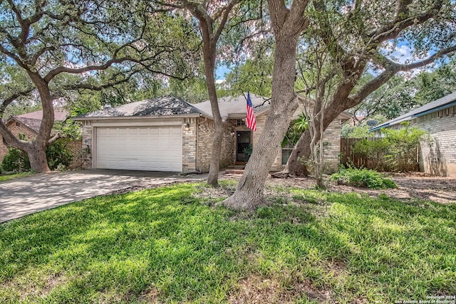 view of front of house featuring brick siding, concrete driveway, an attached garage, fence, and a front lawn