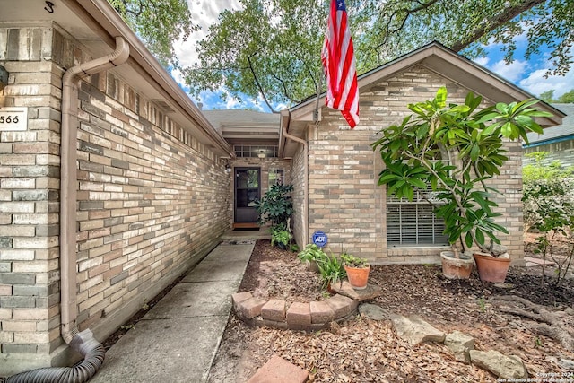 view of exterior entry with brick siding