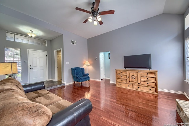 living room with visible vents, ceiling fan, baseboards, and wood finished floors