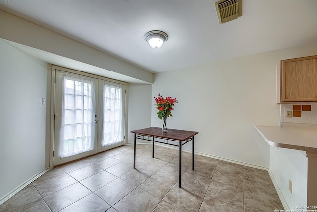 office space featuring light tile patterned floors, french doors, visible vents, and baseboards