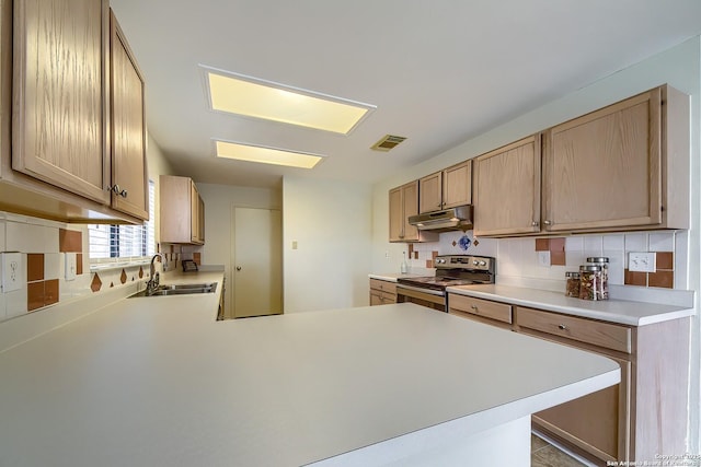 kitchen featuring visible vents, a peninsula, stainless steel electric stove, under cabinet range hood, and a sink