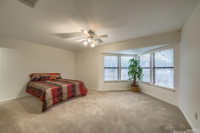 bedroom with a ceiling fan, carpet flooring, visible vents, and baseboards