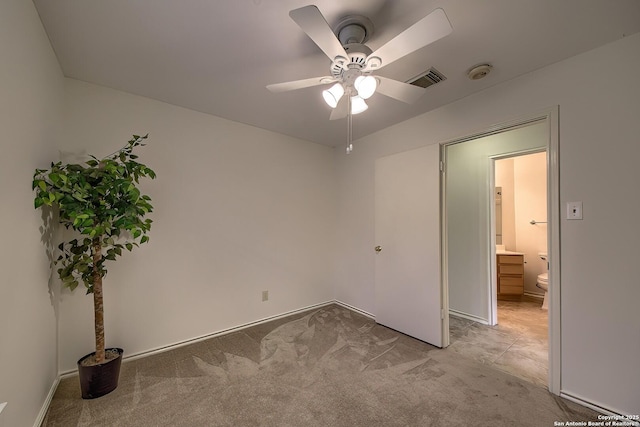 unfurnished bedroom with a ceiling fan, visible vents, and light colored carpet