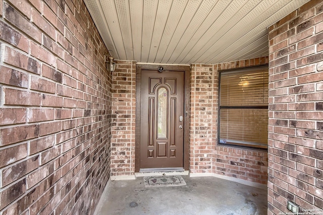 property entrance with brick siding