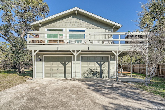 view of front of property with fence, driveway, and an attached garage