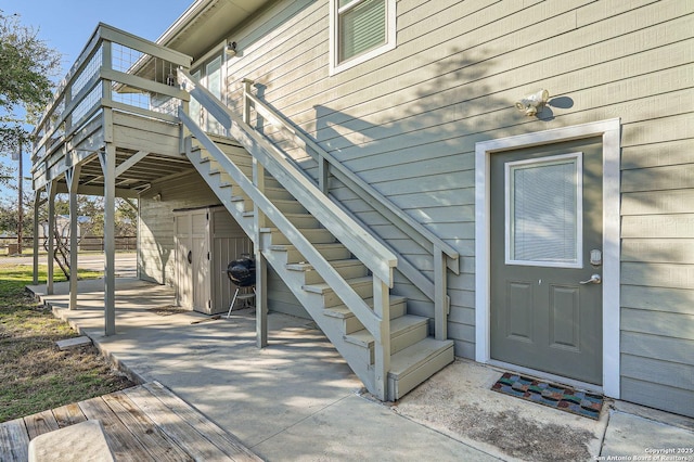 entrance to property featuring a deck and a patio