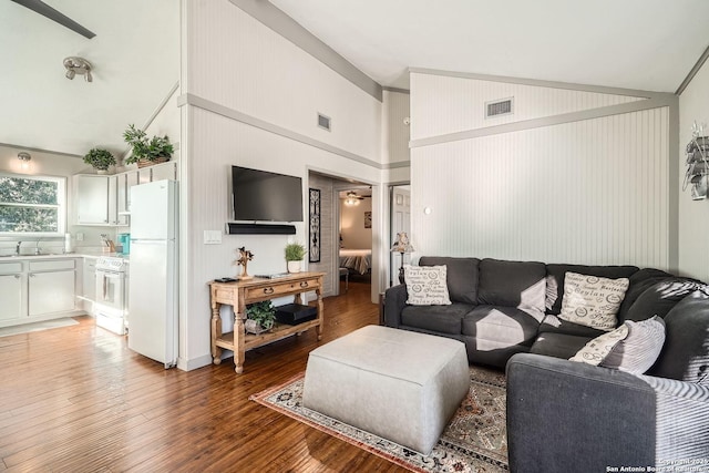 living room with light wood-style floors, visible vents, and high vaulted ceiling