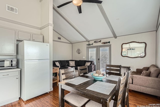 dining space featuring ceiling fan, visible vents, vaulted ceiling, french doors, and light wood finished floors