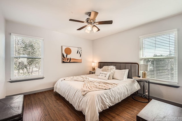 bedroom featuring a ceiling fan, baseboards, and wood finished floors