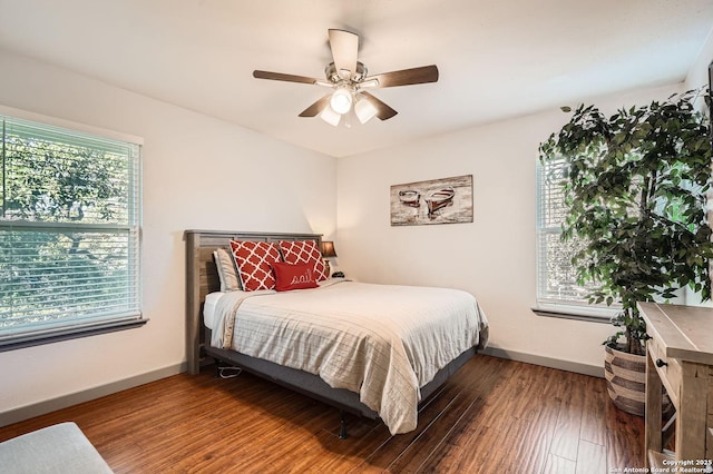 bedroom with ceiling fan, baseboards, and wood finished floors