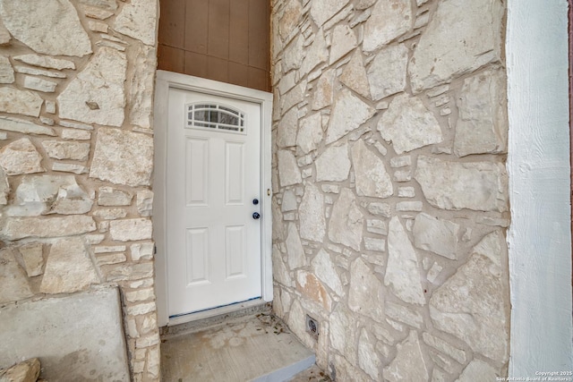 entrance to property featuring stone siding