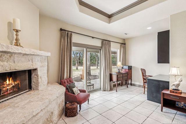 office area with crown molding, a tray ceiling, a fireplace, and light tile patterned floors