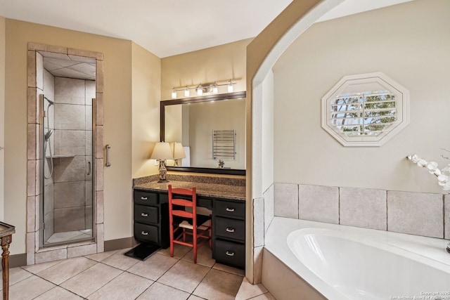 bathroom with a bath, a stall shower, vanity, and tile patterned floors