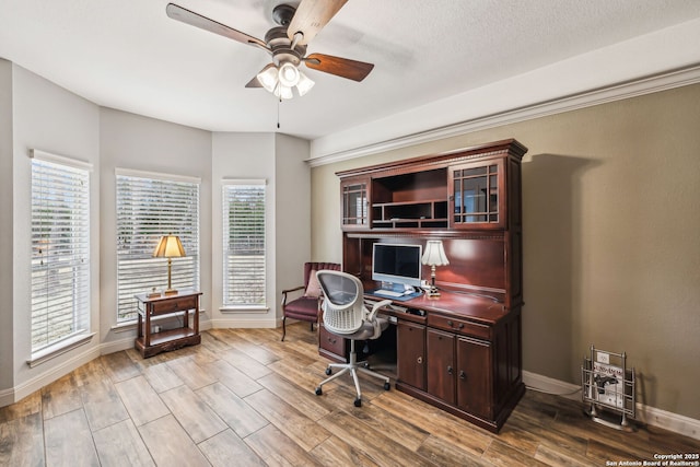 office space featuring wood finished floors, a ceiling fan, and baseboards