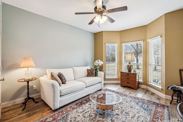 living area featuring ceiling fan, wood finished floors, and baseboards