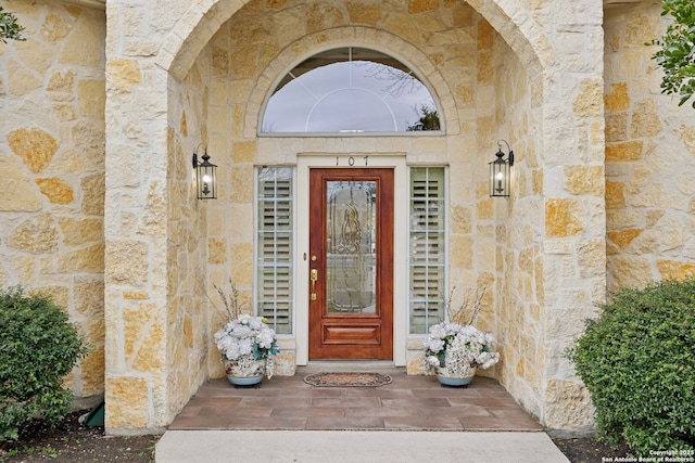 entrance to property featuring stone siding