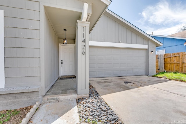 garage with driveway and fence