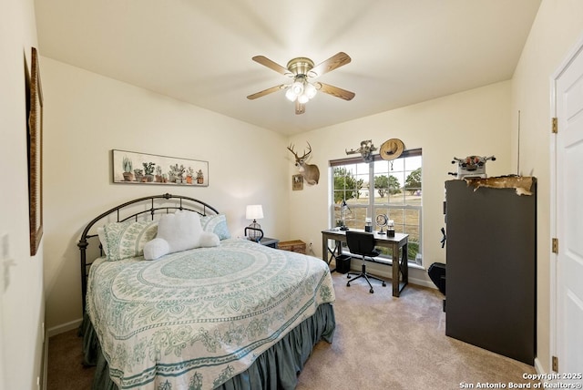 bedroom featuring ceiling fan, baseboards, and light colored carpet