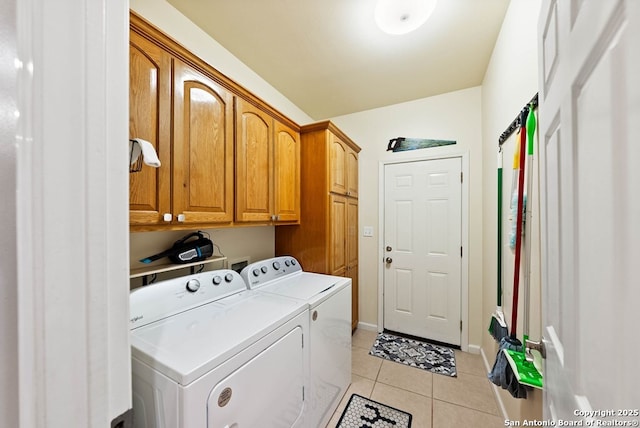 washroom featuring cabinet space, baseboards, separate washer and dryer, and light tile patterned flooring