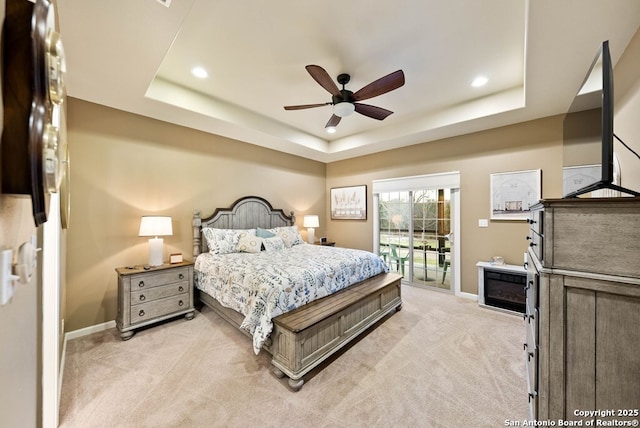 bedroom featuring recessed lighting, light colored carpet, baseboards, access to exterior, and a raised ceiling