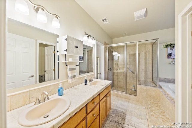 full bath featuring double vanity, a stall shower, a sink, and visible vents