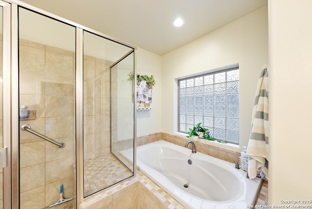 full bathroom with a stall shower, a garden tub, and recessed lighting