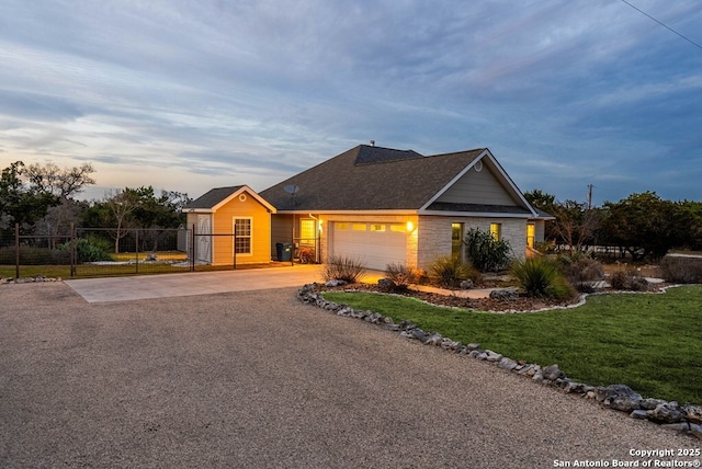 view of front of property featuring driveway, an attached garage, fence, and a front lawn