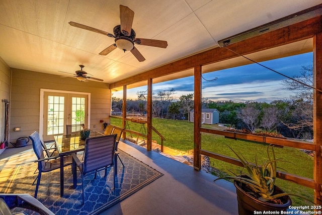 sunroom / solarium featuring french doors