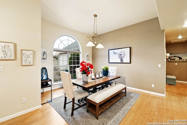 dining space with light wood-style floors, baseboards, and visible vents