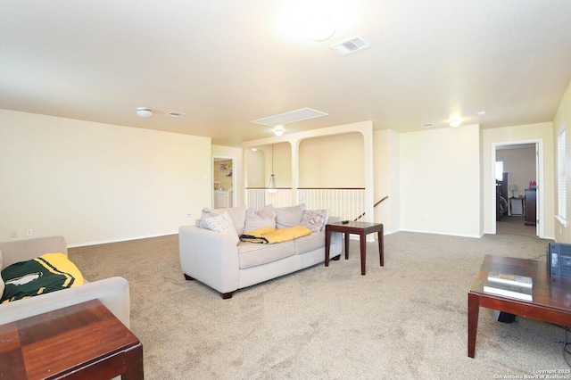 carpeted living area with visible vents and baseboards