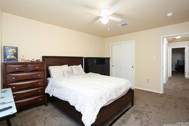 carpeted bedroom with a ceiling fan, baseboards, visible vents, and a closet