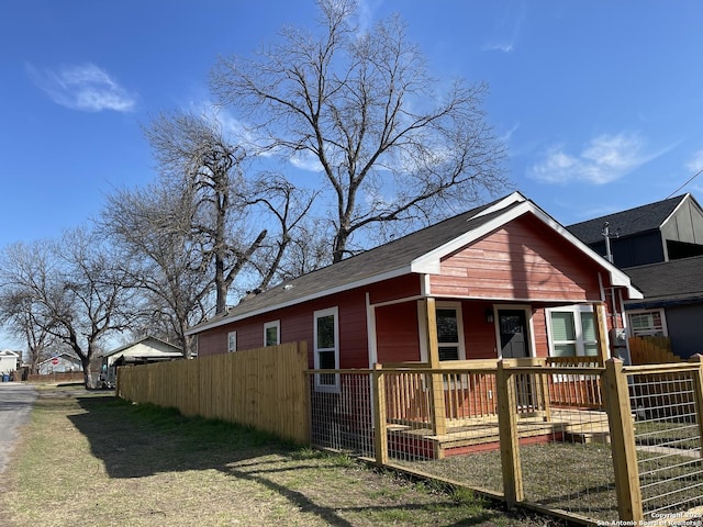 exterior space featuring covered porch and fence