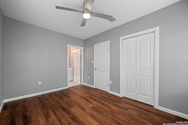 unfurnished bedroom with ceiling fan, a closet, visible vents, wood finished floors, and baseboards